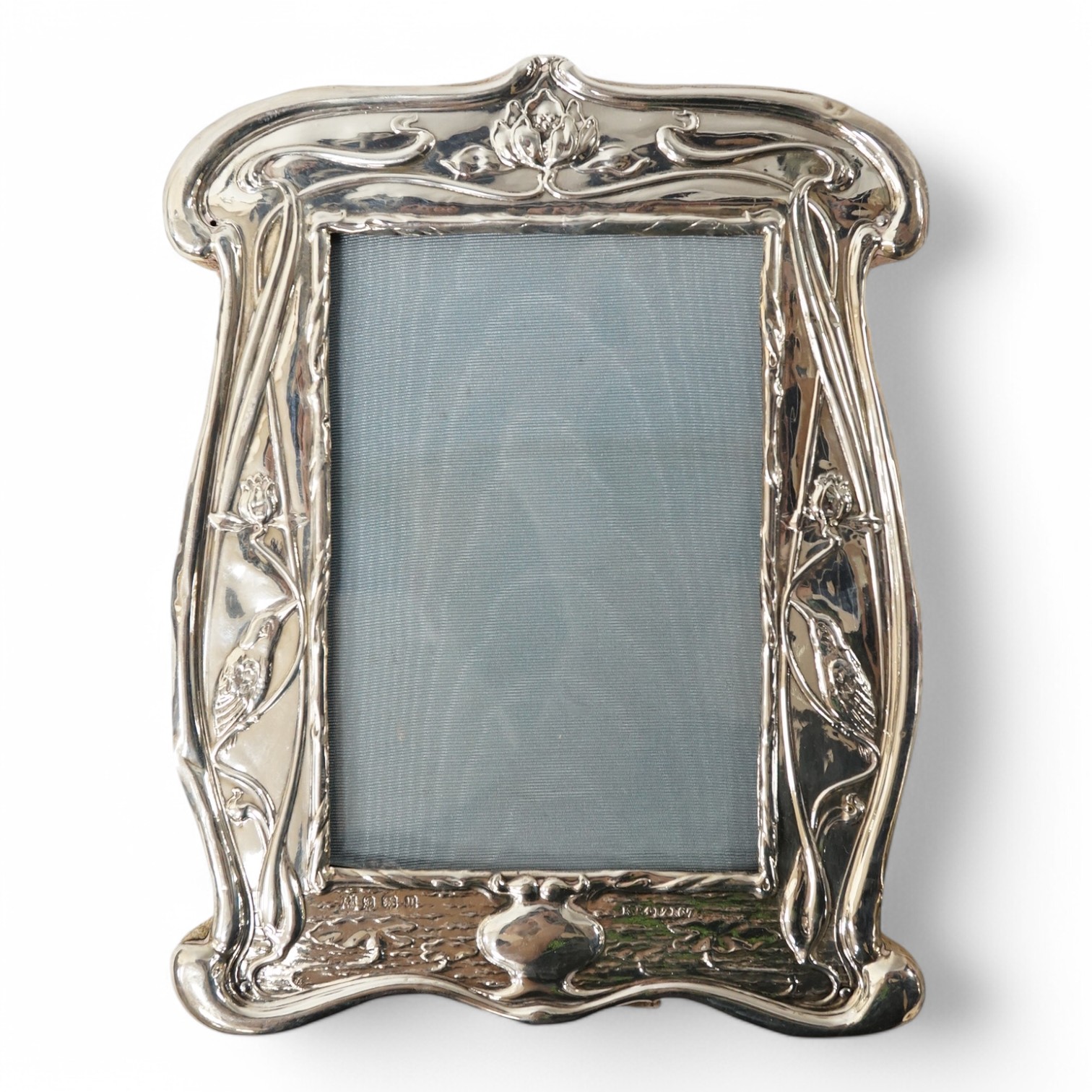 A George V Art Nouveau silver mounted photograph frame, with stylised decoration, William Neale & Son Ltd, Birmingham, 1912, 21.2cm. Condition - poor to fair